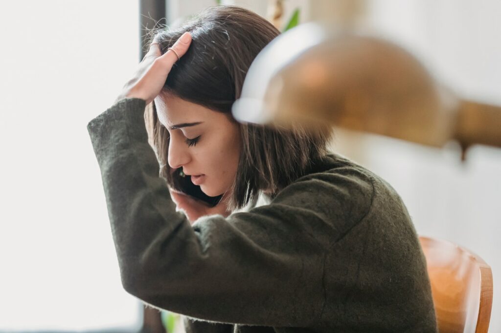 Woman on phone, speaking to insurance company